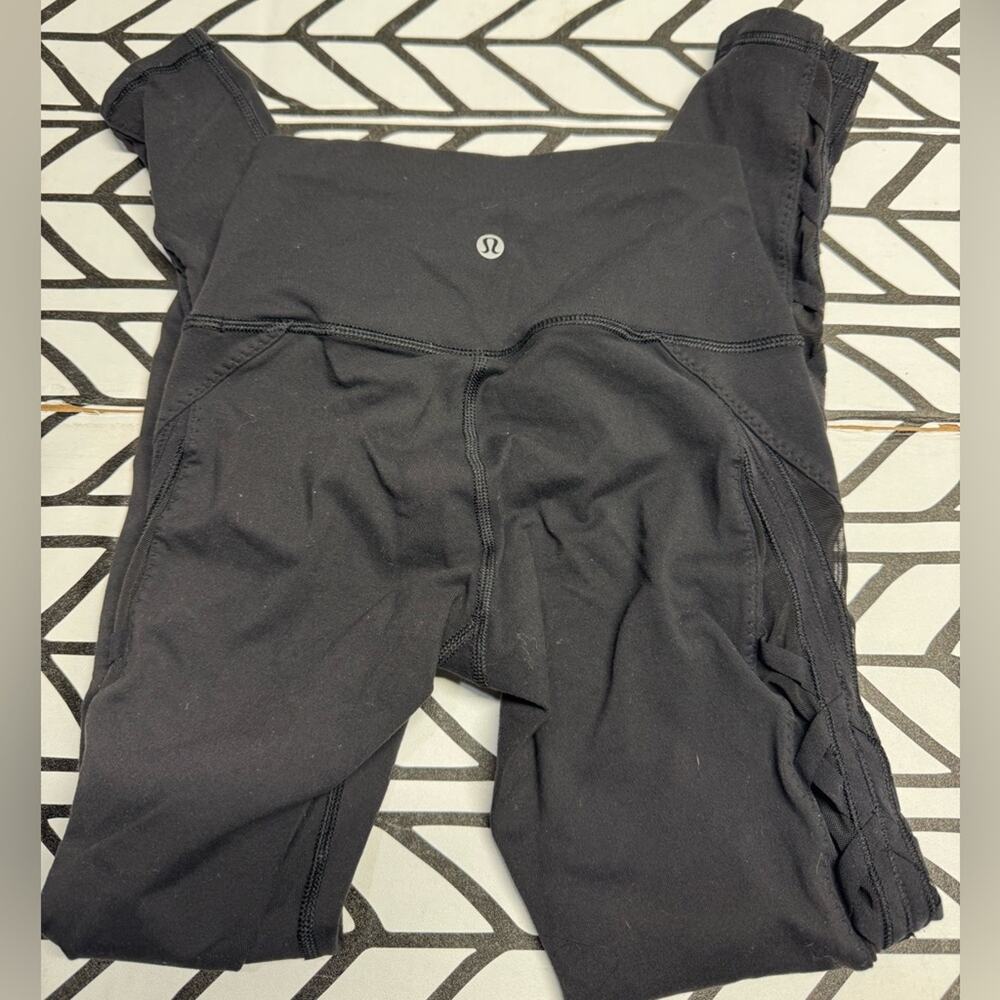 Lululemon Black Leggings with Sheer side panels with Criss Cross details- size 2